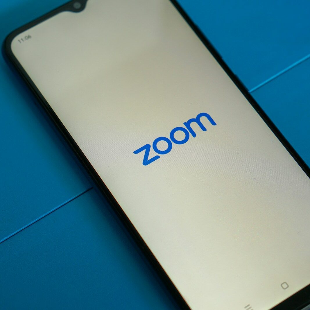 a close up of a cell phone with the zoom logo on it